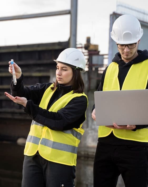 Dos ingenieros, un hombre y una mujer, realizando pruebas ambientales en el servicio de gestión ambiental minera